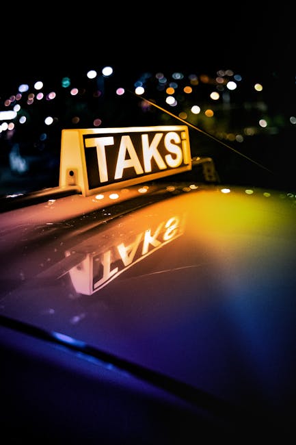 Illuminated TAKSI sign reflected on taxi roof in Albania