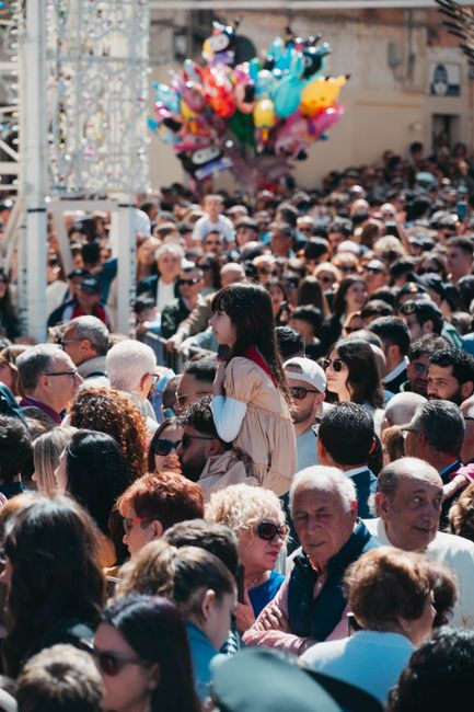 Foule dense lors d'une fête locale en Albanie, enfant sur les épaules