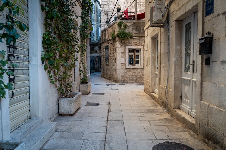 Narrow stone alley in Split's Old Town with potted vines