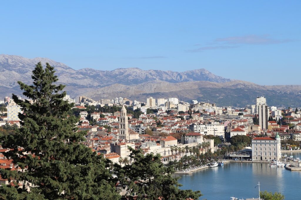 Panoramic view of Split harbor, red roofs and distant mountains