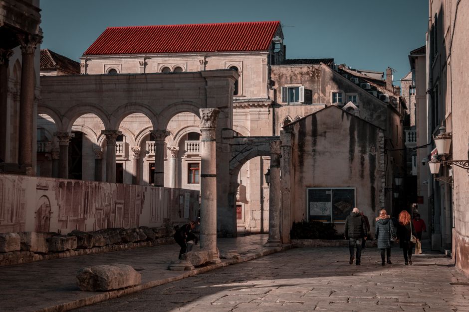 Narrow palace street lit by golden morning light