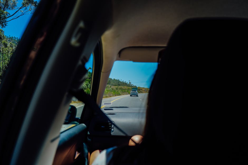 Car driving on a scenic road towards Plitvice
