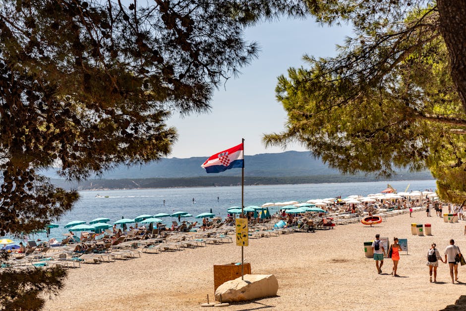 Family preparing a picnic on a pebbled beach along Hvar’s coastline