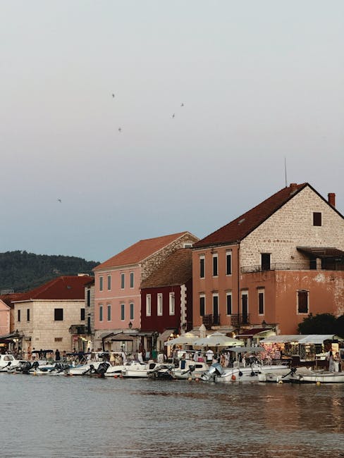 Hvar Town harbor at sunset with boats and Trg Svetog Stjepana