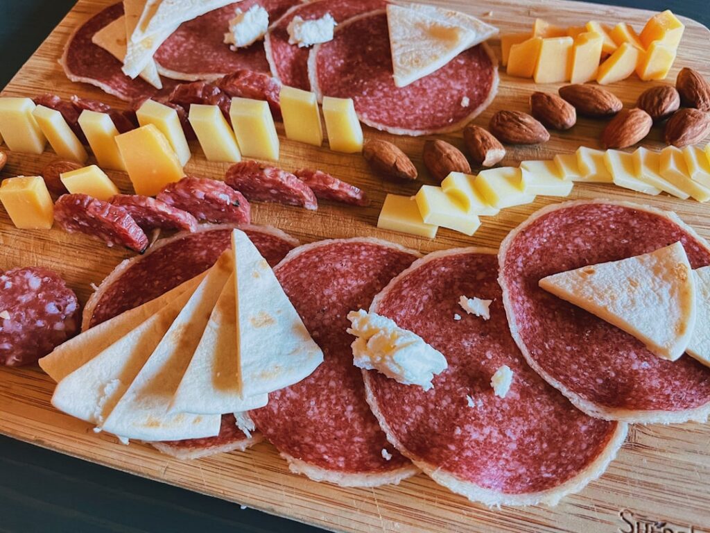 Wine bar with wooden board of cured meats in Hvar at dusk