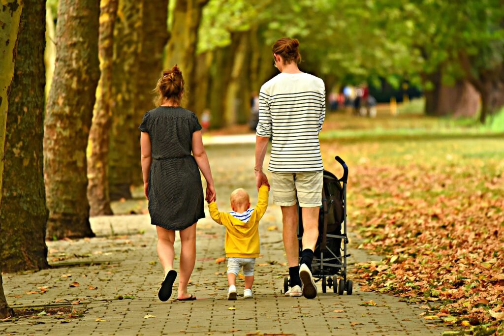 Famiglia che passeggia sulla spiaggia della Barceloneta con passeggino