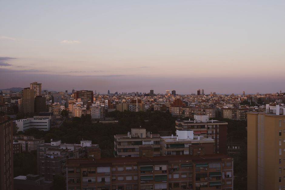 Sunset over Barcelona cityscape from a rooftop terrace
