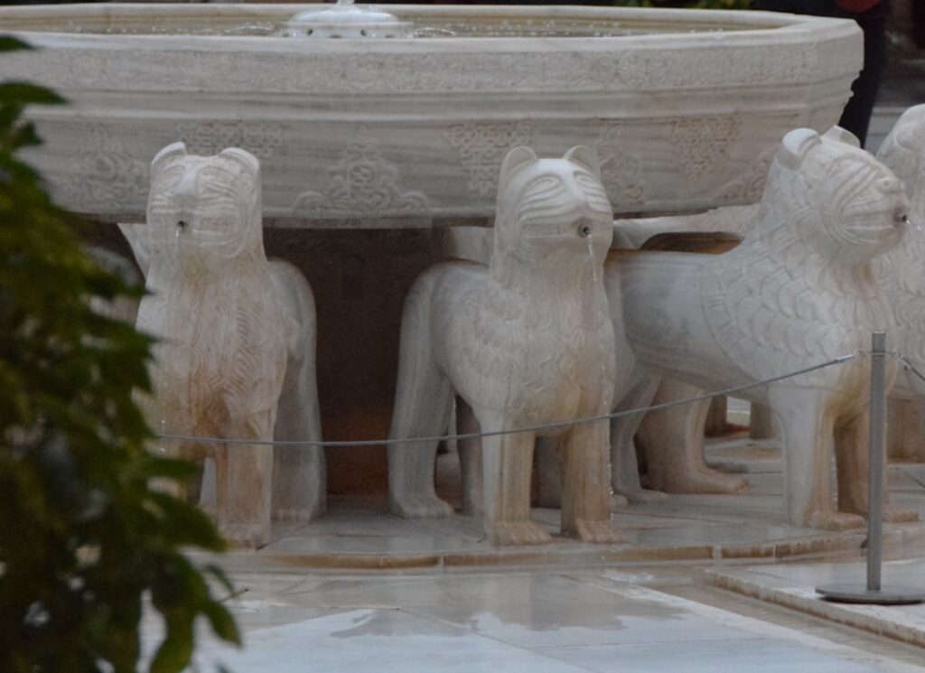 Close-up of the Court of the Lions fountain and one of the marble lions