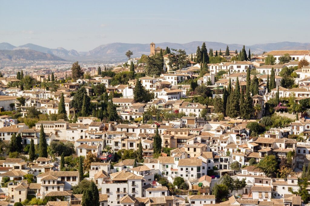 Narrow white houses with flowered balconies in the Albaicín