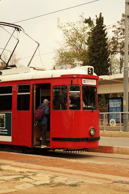 Granada tram at Plaza Nueva stop with passengers