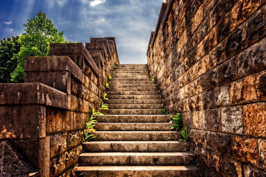 Stone staircases of Praza da Quintana bathed in morning light