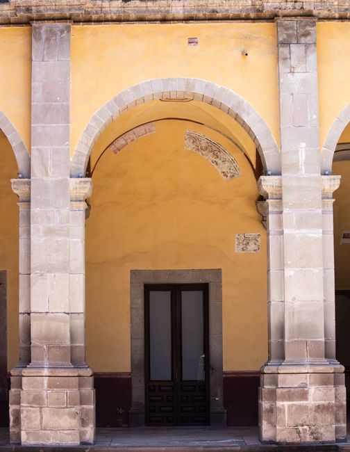Historic palace courtyard with stone arches at Pazo de Xelmírez