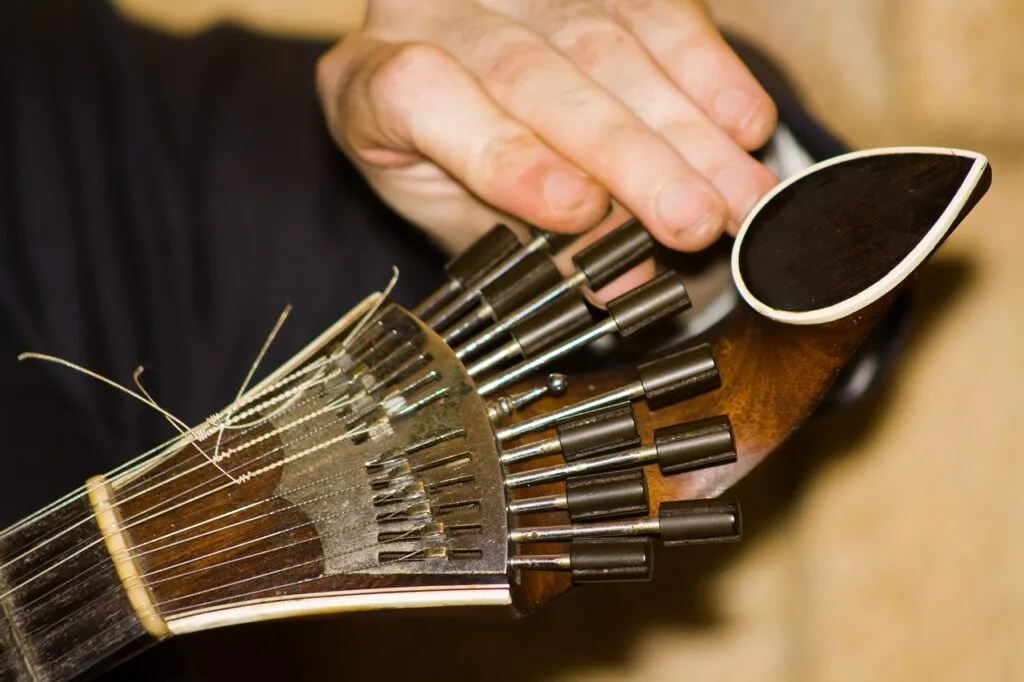 Close-up of a Portuguese guitarra headstock and musician's hand, Porto