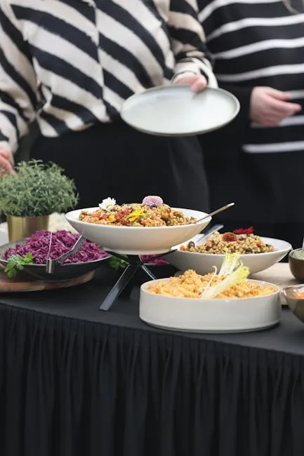 Buffet spread with bowls of colorful salads and diners serving themselves.