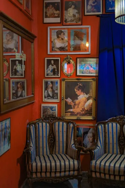 Vintage seating and framed portraits on orange wall in Porto hostel