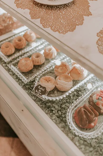 Glass display of small Portuguese pastries on trays in Porto bakery.