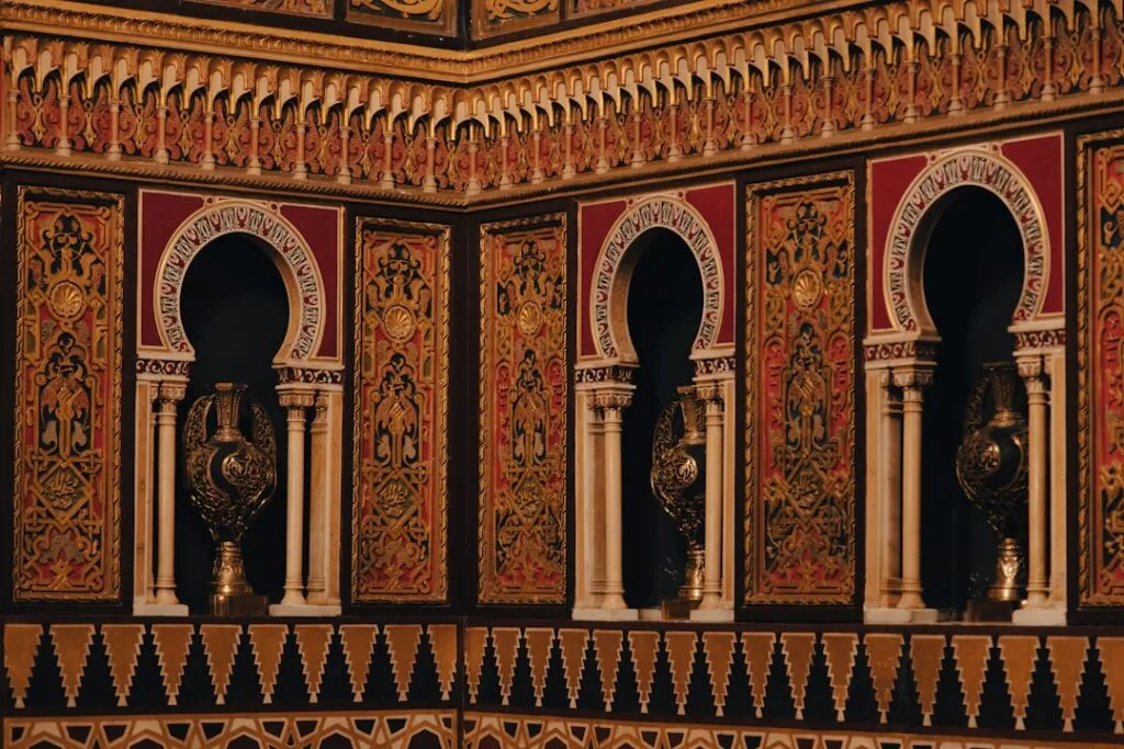 Intricate Arab Room wooden arches and decorative vases at Porto's Palacio