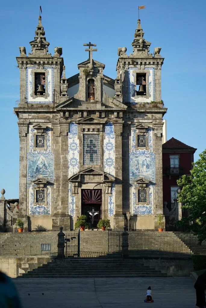 Azulejo-covered church facade with twin bell towers in Porto