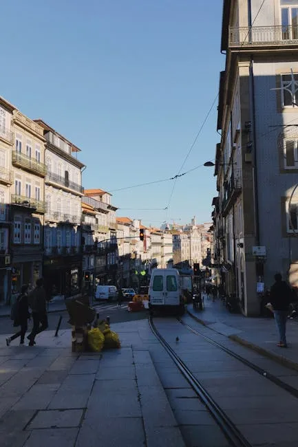 Steep Porto street with tram tracks and traditional narrow buildings