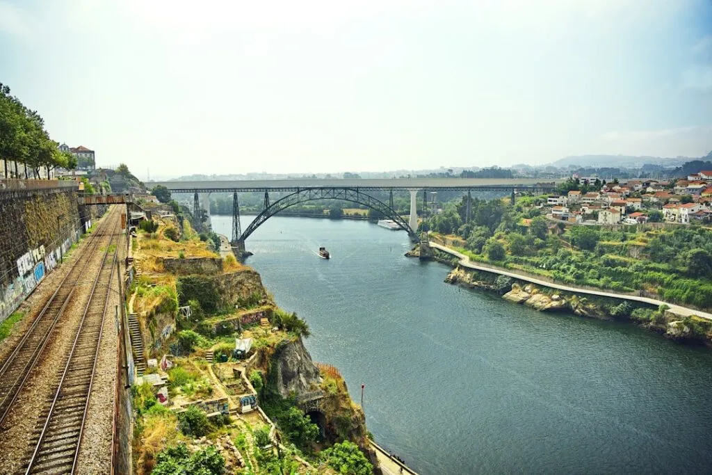 Douro River view in Porto with Dom Luís I Bridge and riverside railway tracks