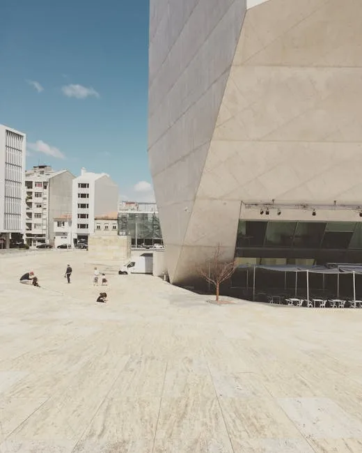 Wide stone plaza beside Casa da Musica in Porto with scattered visitors