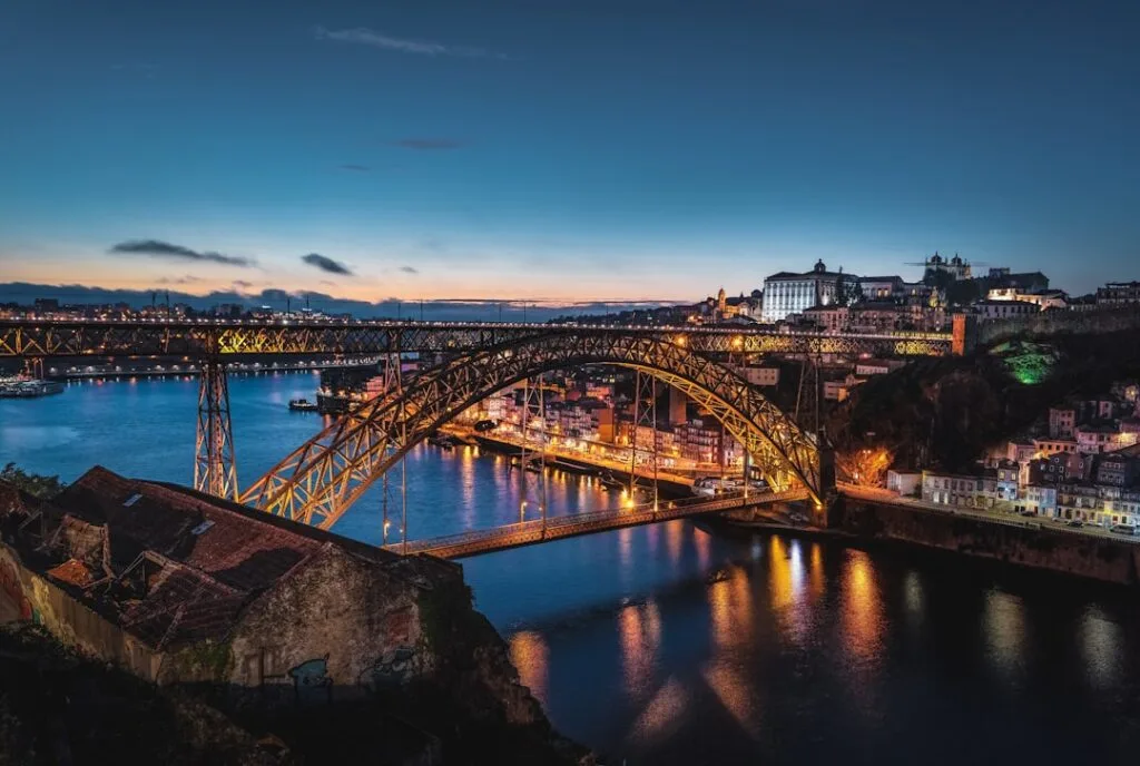 Dom Luís I Bridge lit over the Douro River in Porto at dusk
