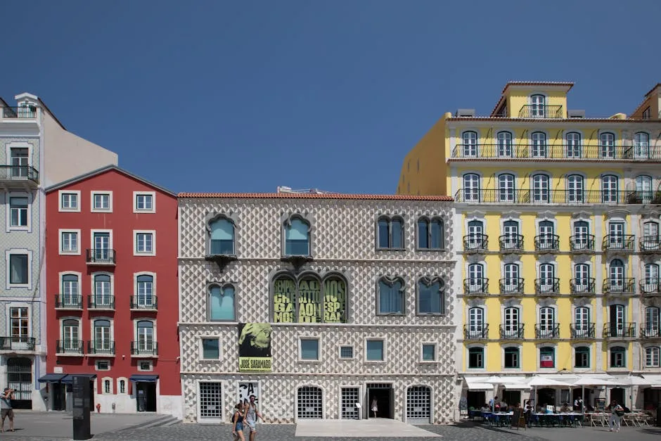 Distinct diamond-patterned façade flanked by red and yellow buildings
