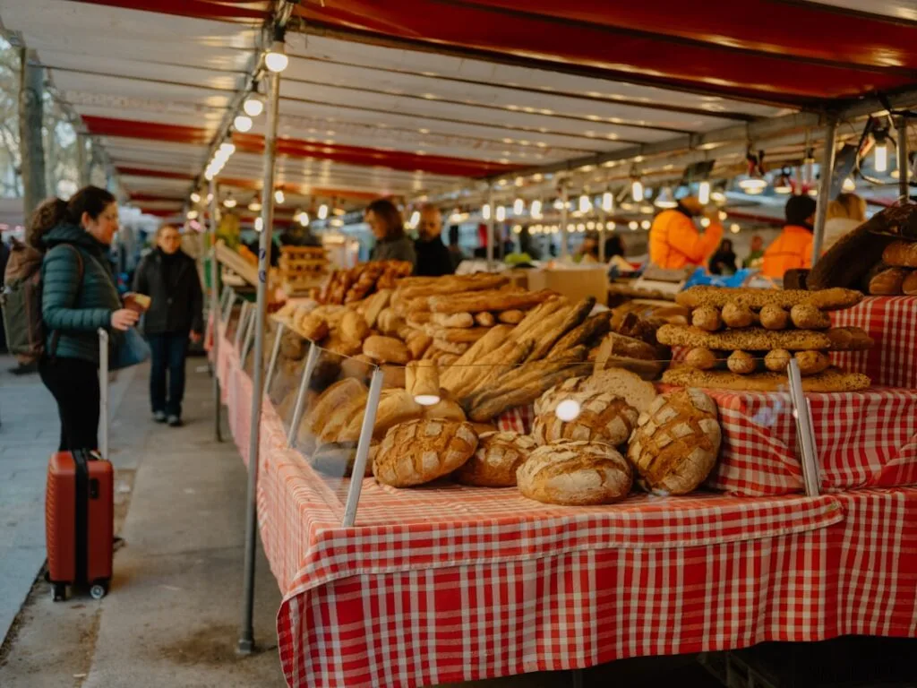 Assortment of breads on a red-checked stall table in Porto