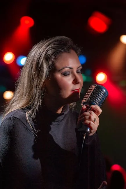Woman singer holding a vintage microphone under colorful stage lights