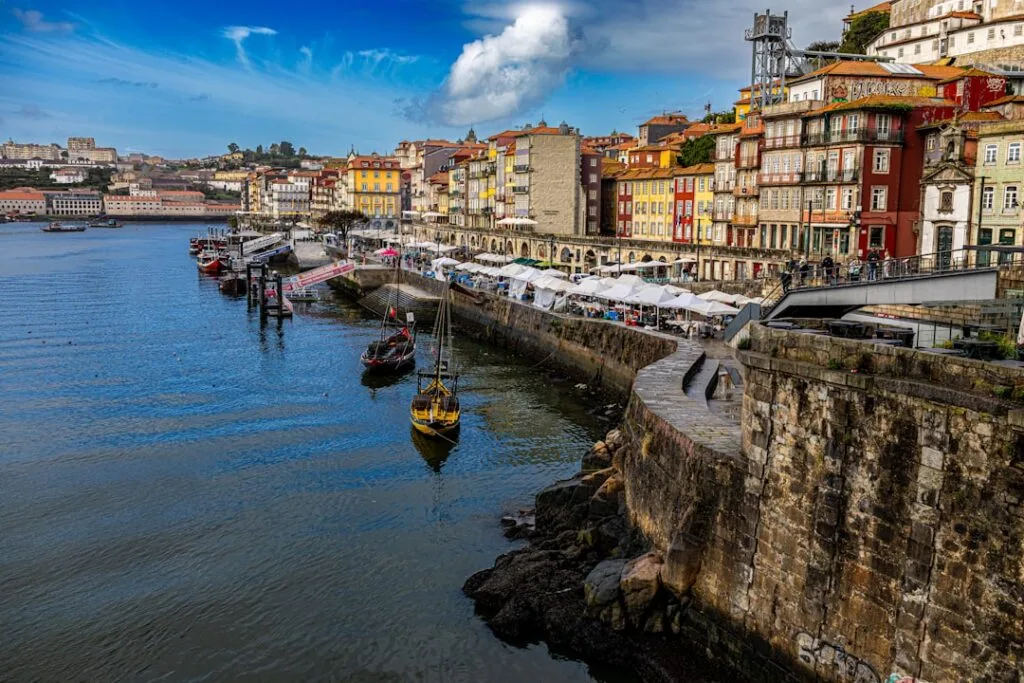 Riverside promenade with tents and colorful houses in Porto's Ribeira