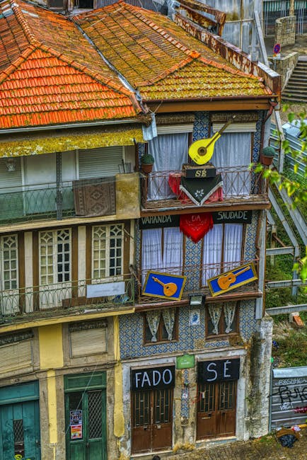 Tiled Porto façade with balconies, painted guitars and 'FADO' entrance