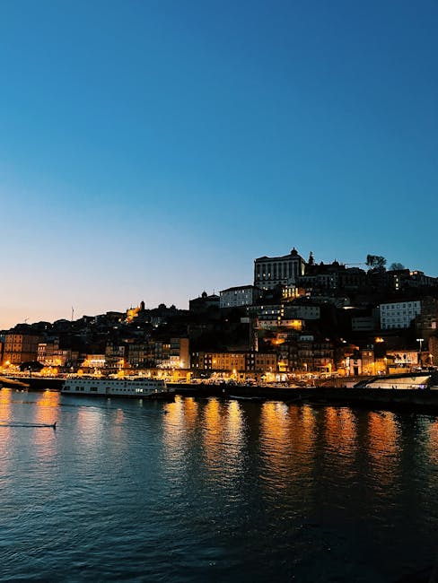 Porto riverside skyline at dusk with illuminated buildings reflecting on water