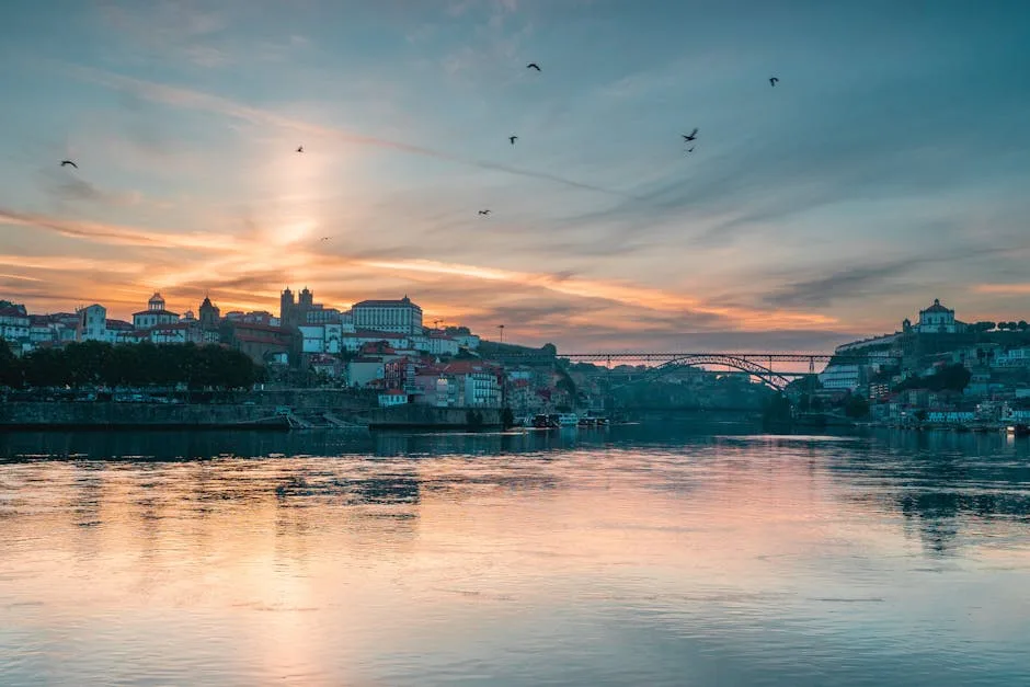 Porto skyline at sunset reflected on the Douro River