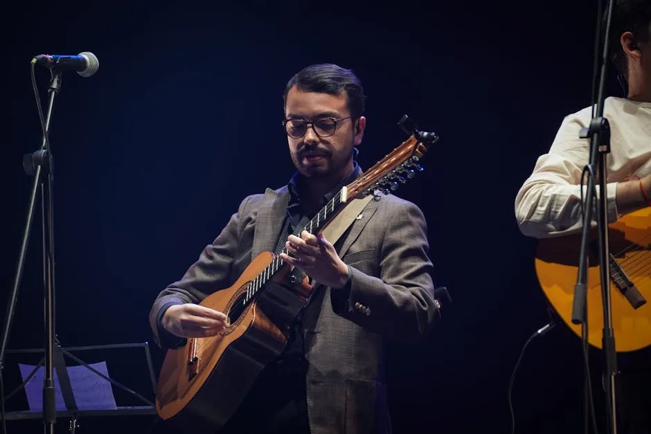 Musician wearing glasses playing Portuguese guitar onstage in Porto