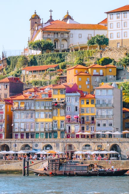 Colorful Porto Ribeira waterfront buildings with boats and riverside cafes