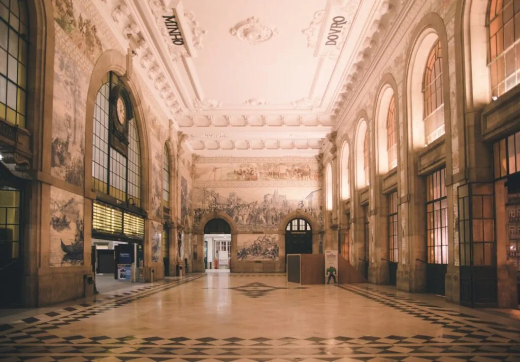 Ornate São Bento station hall with azulejo tile murals and arched windows, Porto