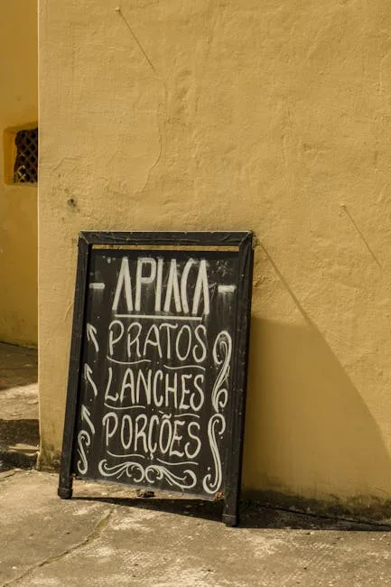 Chalkboard menu leaning against yellow wall listing Portuguese dishes in Porto alley