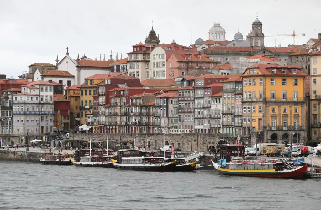 Rabelo boats moored along Porto's Ribeira with colorful riverside buildings