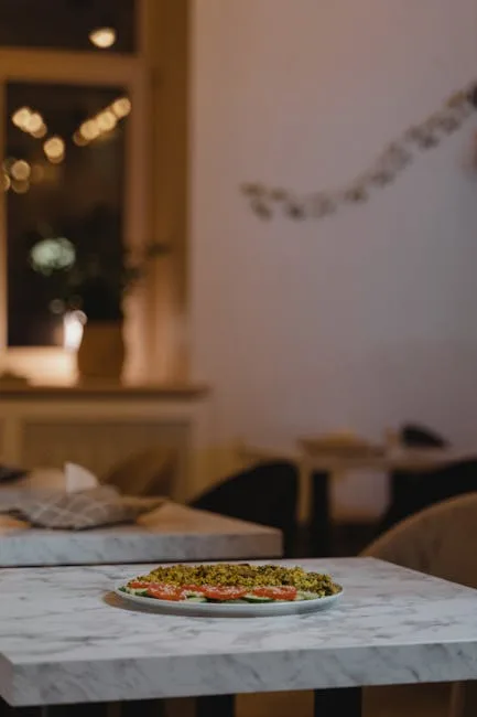 Plated vegan dish on a marble table inside a cozy Porto restaurant