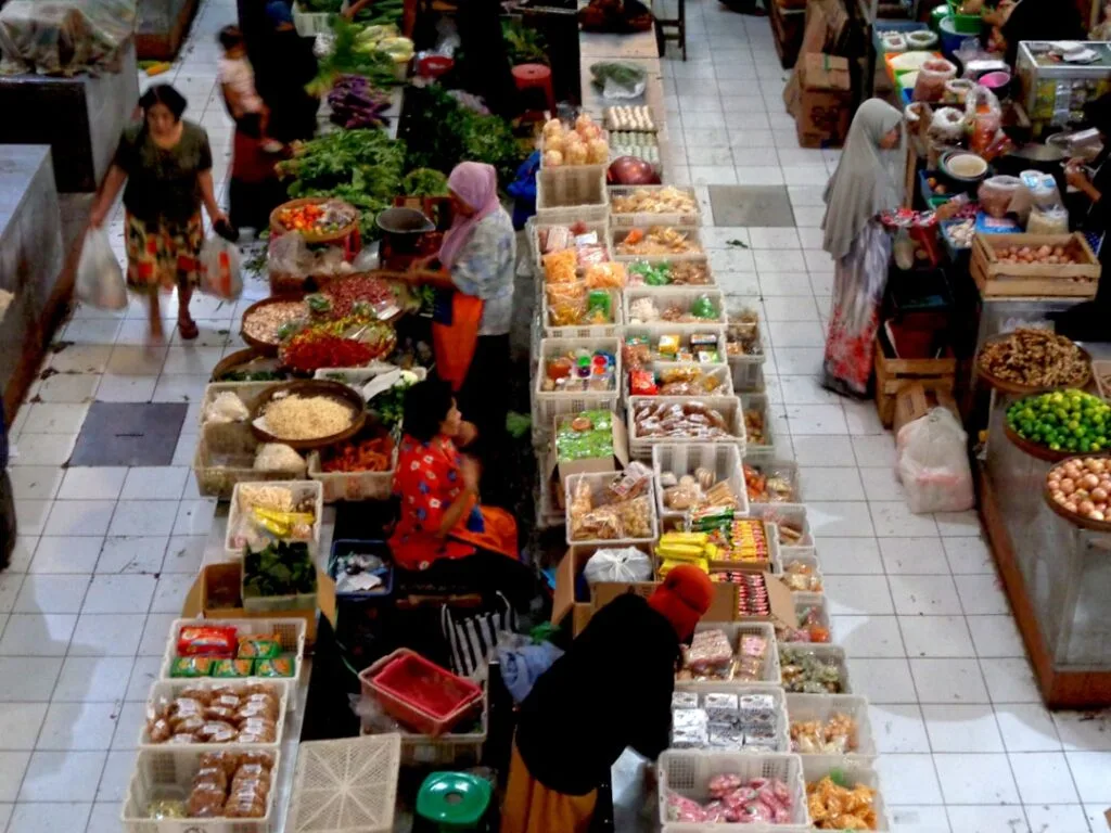 Overhead view of crowded indoor market stalls selling produce and packaged goods