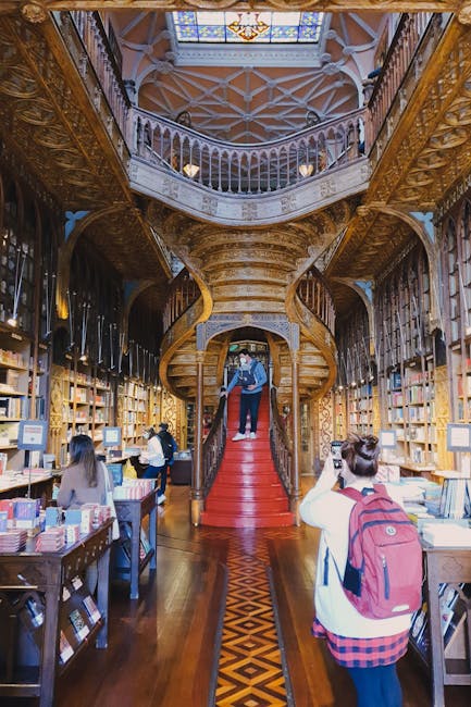 Ornate wooden interior and red spiral staircase inside Livraria Lello in Porto