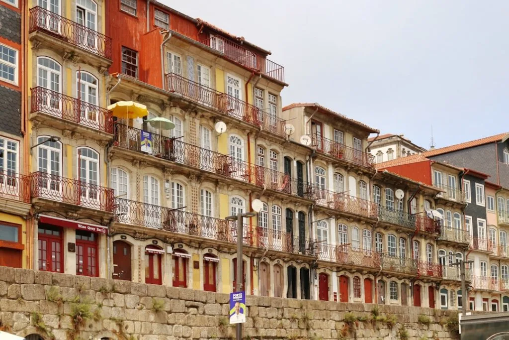 Colorful riverside buildings with ornate balconies along Porto's Ribeira quay