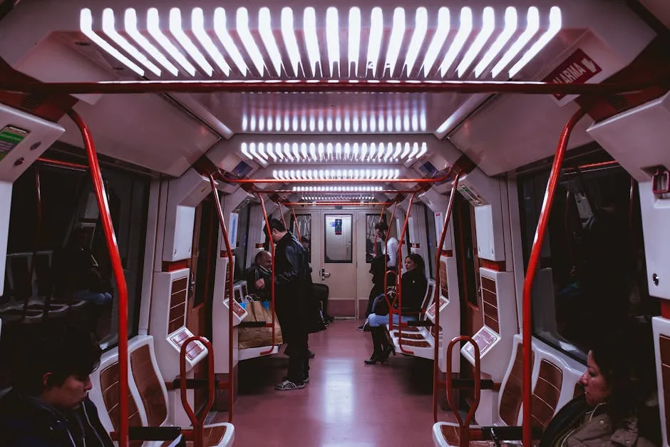 Interior of a Porto metro car with red handrails and passengers