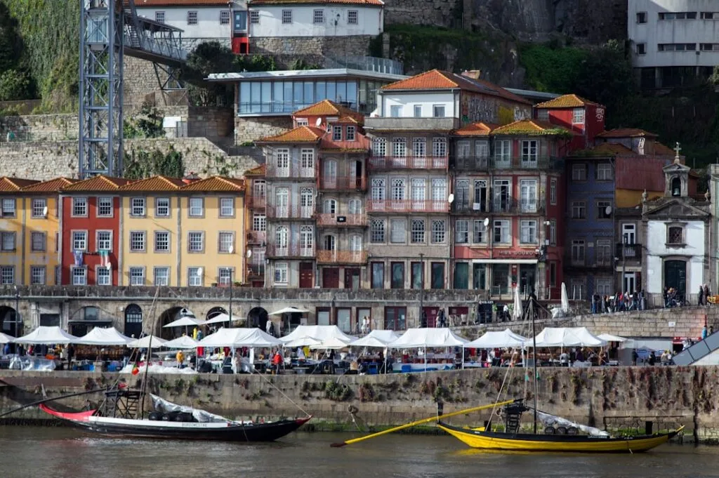 Colourful Ribeira buildings and boats along Porto's Douro riverfront market.