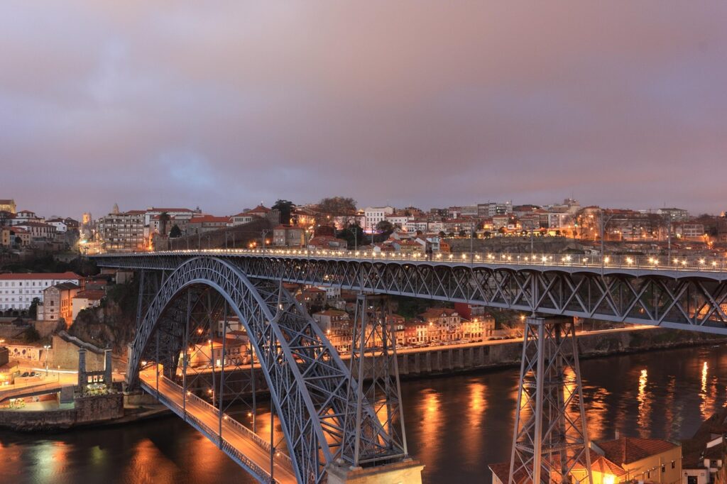 Dom Luís I Bridge spanning the Douro River with Porto city lights at dusk