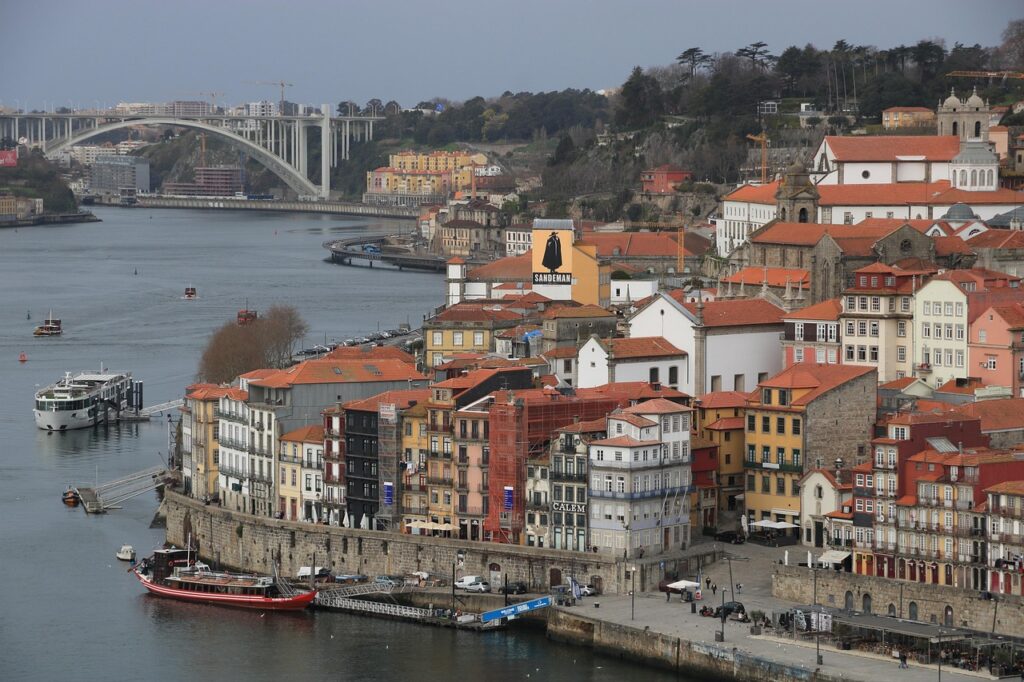 Colourful Ribeira riverside buildings and boats along the Douro in Porto