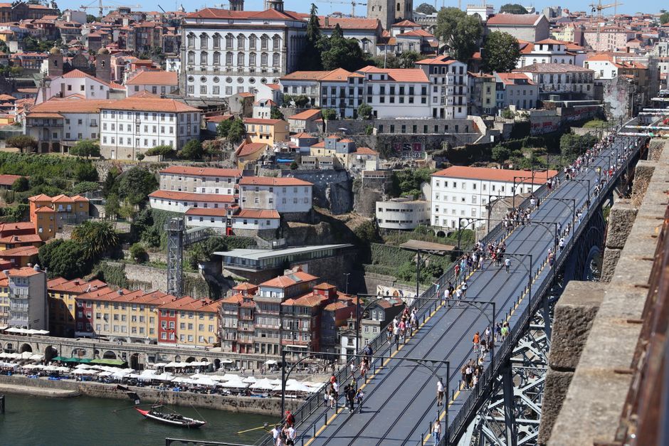 Crowds walking across Dom Luís I Bridge upper deck in Porto