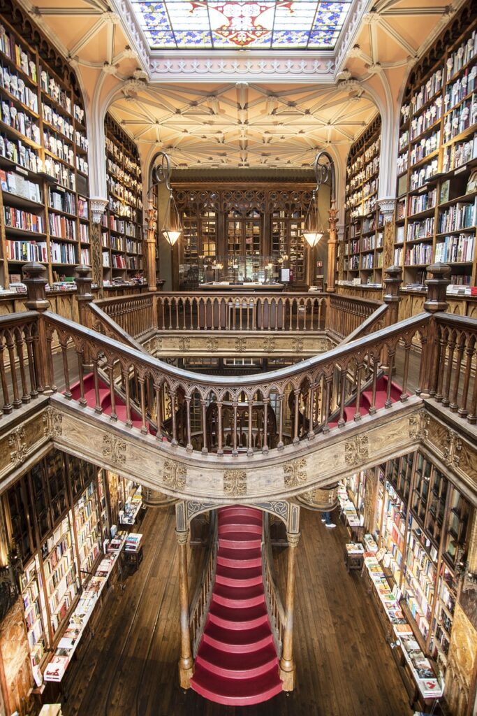 Ornate Livraria Lello interior with red staircase and stained glass ceiling, Porto
