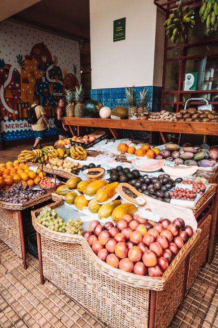 Colorful fruit display in woven baskets at Porto's Mercado do Bolhão