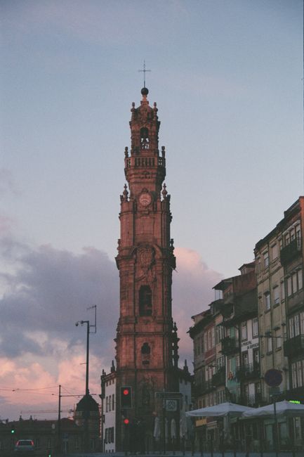 Clérigos Tower rising above Porto streets against dusky pink sky